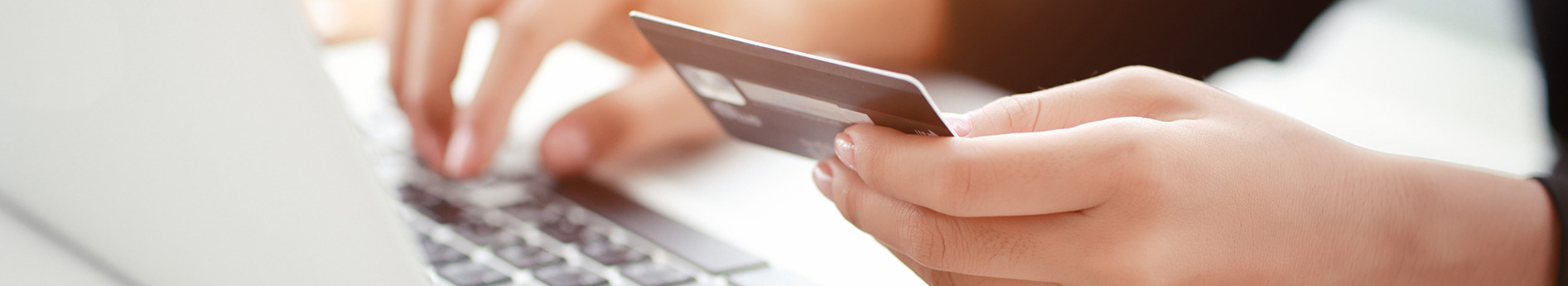 Person making online payment holding a credit card